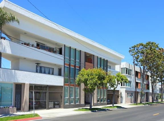 A modern building with a white facade and large windows.