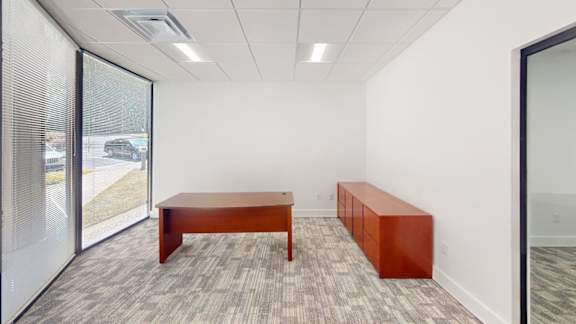 A room with a long table and a bench.