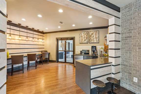 A kitchen with a bar area and a dining table.
