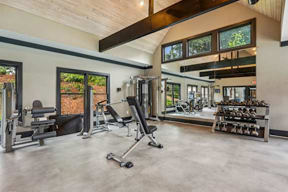 A spacious home gym with a variety of equipment.