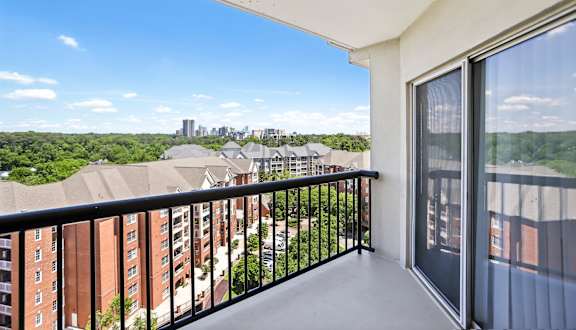 A balcony with a view of a city skyline.