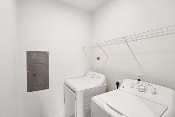 A white washing machine and dryer in a laundry room.