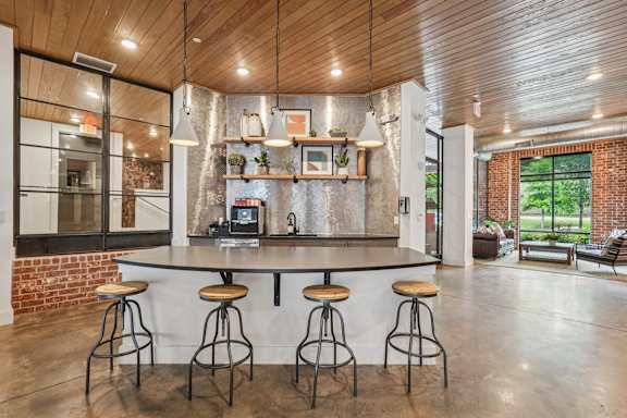 A kitchen with a bar area and Coffee station