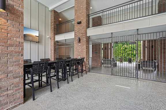 outdoor dining table area with flat-screen TVs