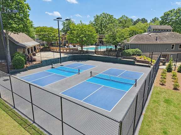 A tennis court surrounded by a fence.
