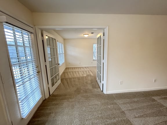 the living room and dining room of an empty home