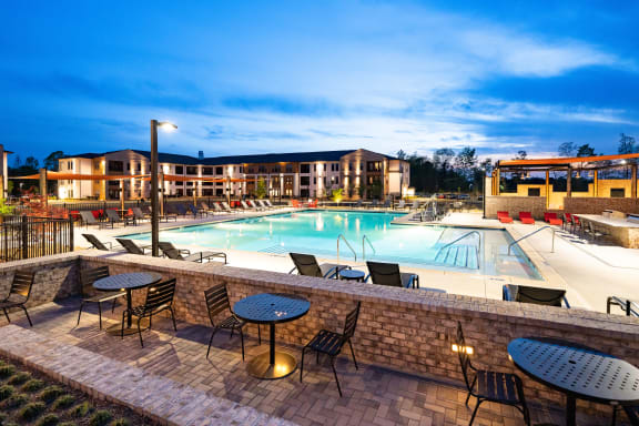 Resort style pool with sun deck and grill area