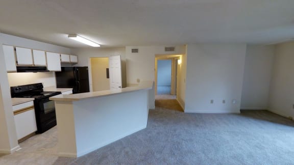 A kitchen with black appliances and white cabinets.