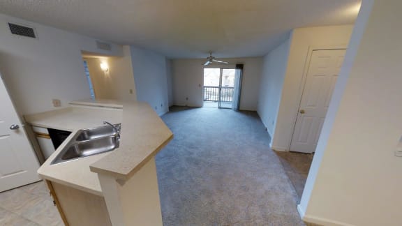 A kitchen area with a sink and a window.
