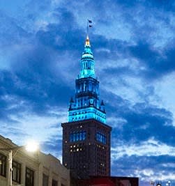 The Terminal Tower building is lit up in blue, apartments for rent in Cleveland.