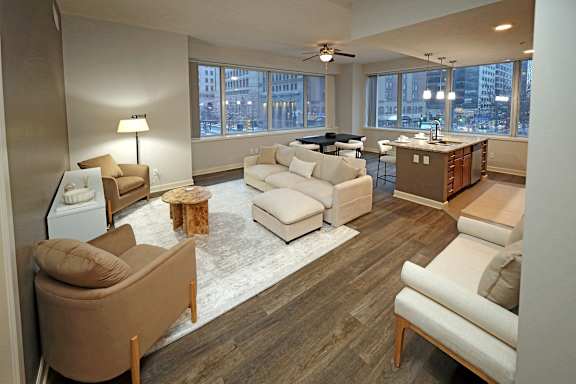 A living room with a brown couch and a white couch.