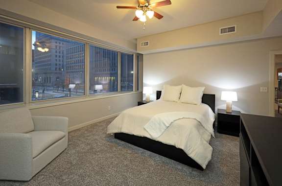 A bedroom with a large bed and a couch.