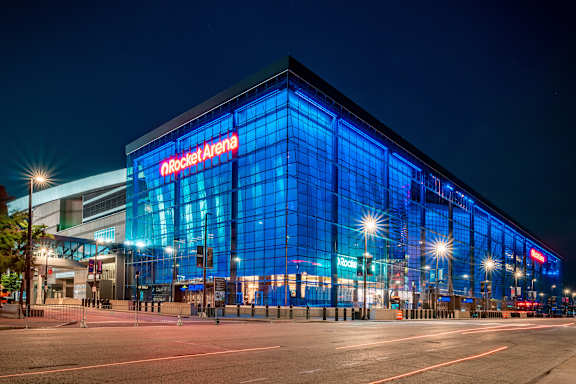 The Rocket Arena is a large, modern building with a glass facade and blue lighting.