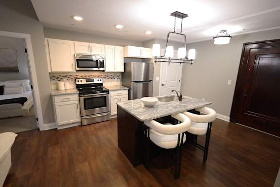 A kitchen with a table and chairs in the middle of it.