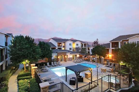 A residential area with a swimming pool and a fence.