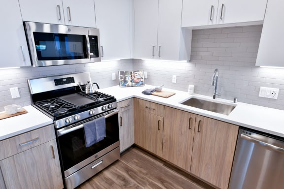 a kitchen with white cabinets and stainless steel appliances