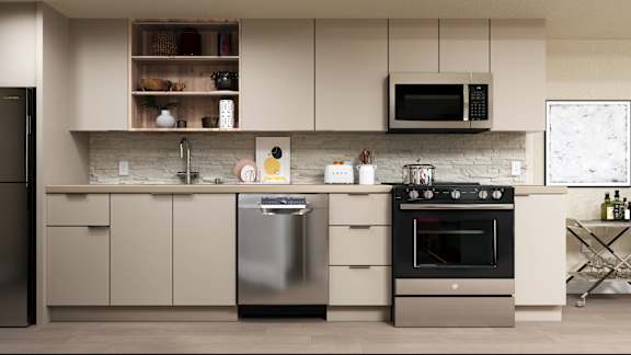 A modern kitchen with a stainless steel dishwasher and oven at Skyview Sunset Apartments, Los Angeles