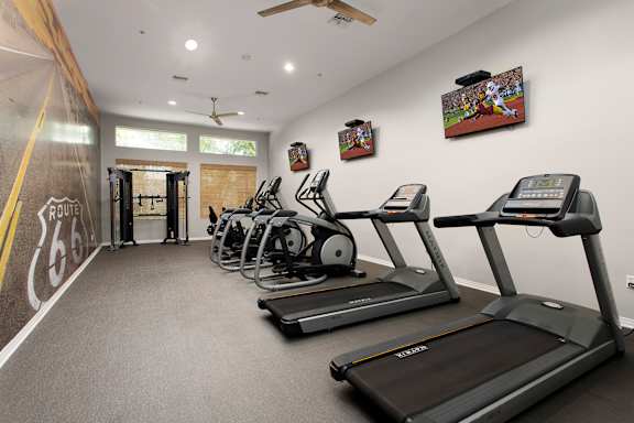 A gym with treadmills and exercise equipment. at 55+ FountainGlen Terra Vista, California, 91730