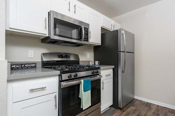 A kitchen with a black refrigerator, stove, and microwave. at 55+ FountainGlen Temecula, Temecula, CA, 92591