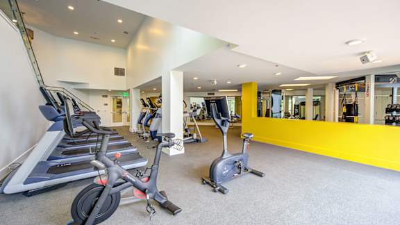A gym with treadmills and exercise bikes. at Baker Block, Costa Mesa, California