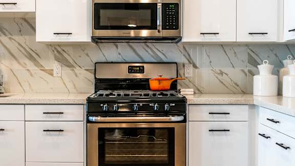 A modern kitchen with a stove, microwave, and oven. at Baker Block, California