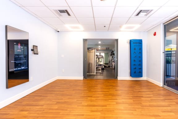 a large room with a wood floor and a blue cylinder in the corner