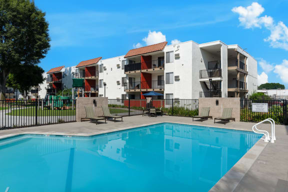 a swimming pool in front of an apartment building