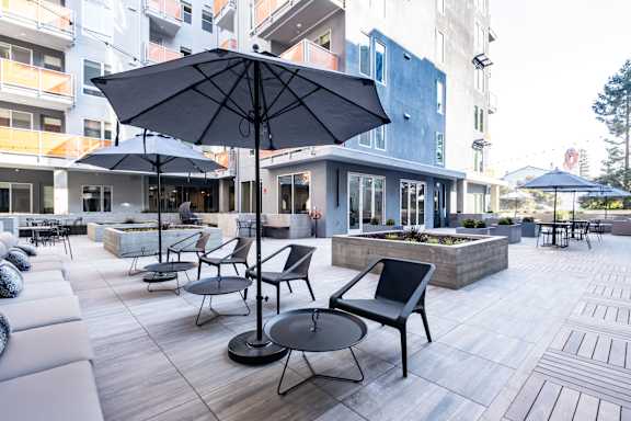 Courtyard with lounge seating and large umbrellas
