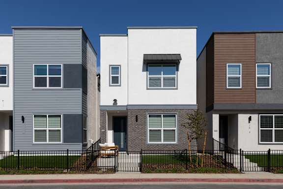 A row of modern townhouses with different colored exteriors.