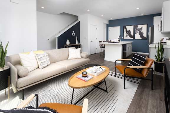 A living room with a couch, a chair, and a coffee table.