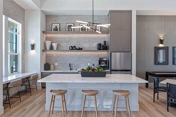 Kitchen with island seating and open shelving at Estia Roseville Apartments, Roseville, California