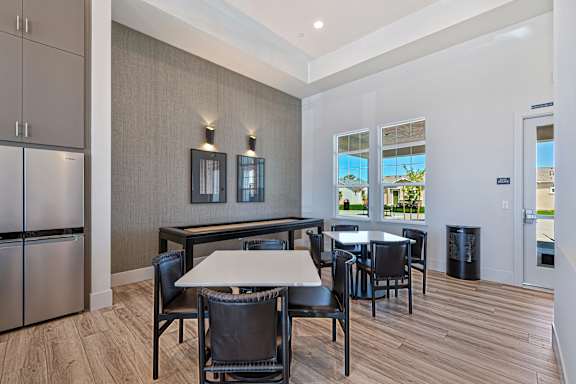 Community lounge with dining area and bar seating at Estia Roseville Apartments, California