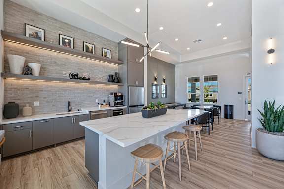 Clubhouse kitchen with waterfall island and open shelving at Estia Roseville Apartments, Roseville, CA