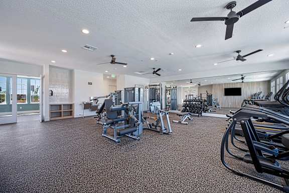 A spacious gym with a variety of exercise equipment.