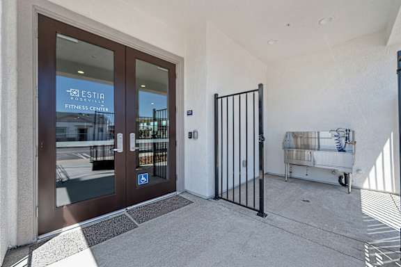 Fitness center entrance with double glass doors at Estia Roseville Apartments, Roseville, CA 95747