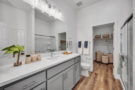 A bathroom with a white countertop and a large mirror.