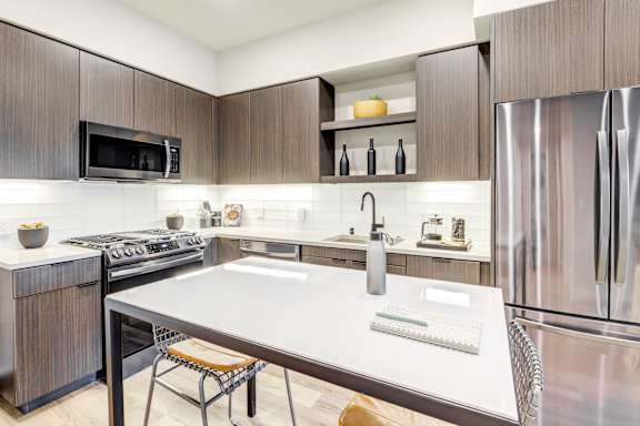 a modern kitchen with slate appliances and wooden cabinets