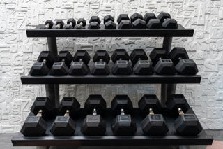 A set of dumbbells on a rack.