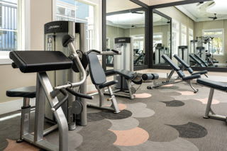 A gym with a variety of equipment including a leg press machine.
