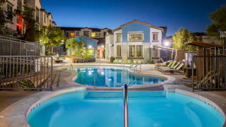 A swimming pool in a residential area at night.