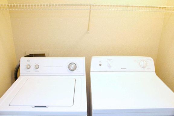 Two white washing machines in a small room at Avalon at Seven Hills Apartments, Henderson, 91790