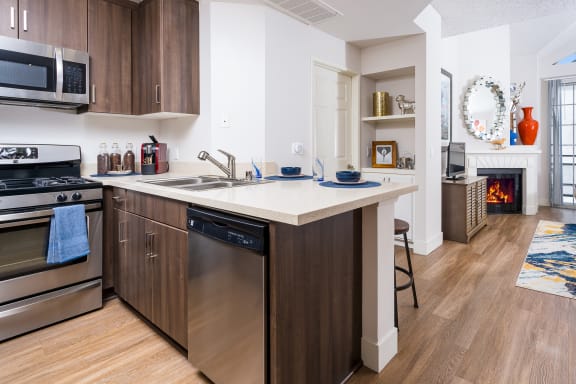 Living room and kitchen with wood flooring at The Preston Miracle Mile Apartments, Los Angeles, 90036