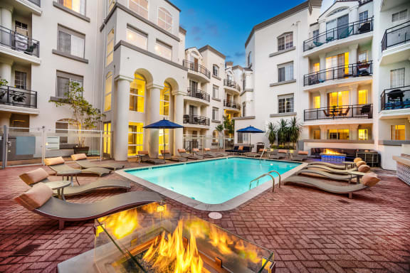 Resort Swimming Pool With Lounge Chairs with firepit at The Preston Miracle Mile Apartments, Los Angeles, CA, California, 90036