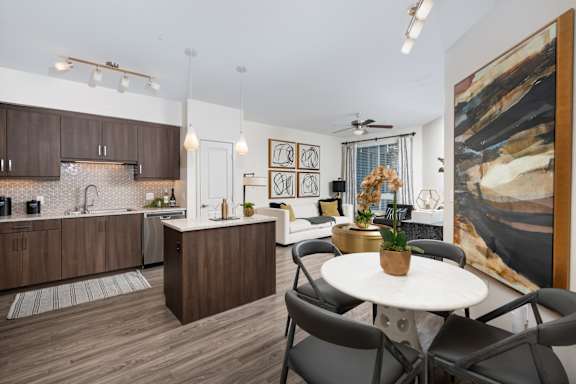 A modern kitchen with brown cabinets and a white island.
