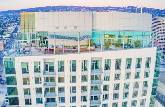 A modern building with a glass facade and a white exterior.