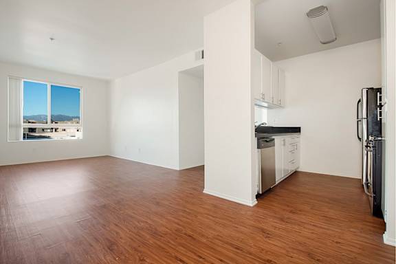 Empty room with wooden floors at Plaza Lafayette, California, 90057