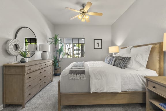 the master bedroom in a new home with a bed and dresser at Vaseo Apartments, Phoenix