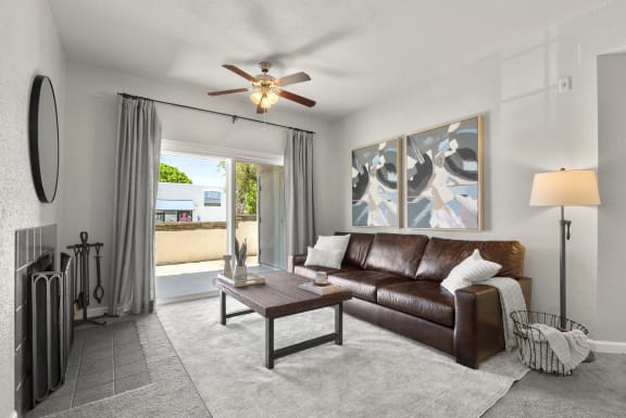 a living room with a couch and a ceiling fan at Vaseo Apartments, Arizona