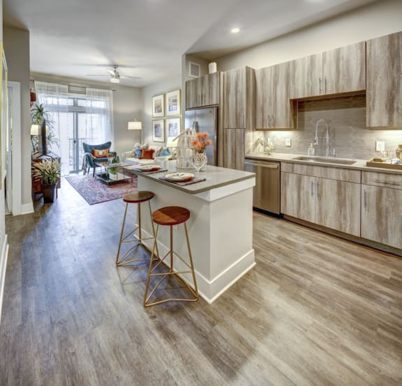 a kitchen with a center island and stools at Arise Riverside, Austin