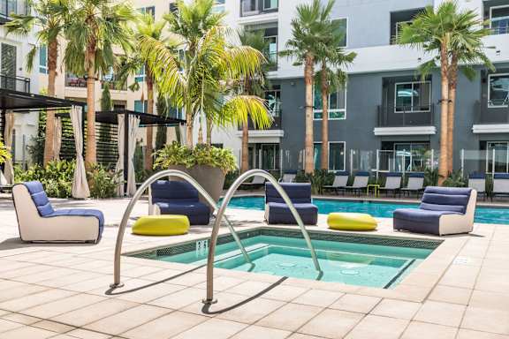 A pool area with a blue and yellow pool chair. at Rize Irvine, Irvine, CA, 92614
